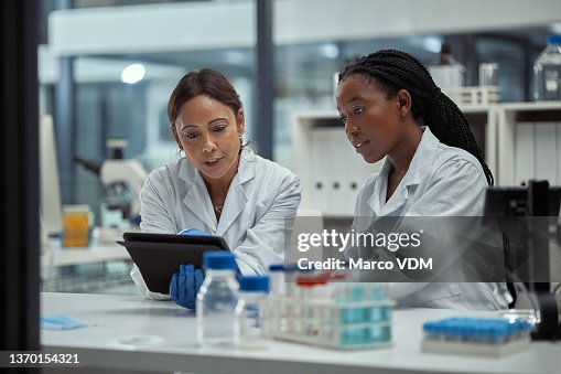 Shot of two scientists working together on a digital tablet in a lab Shot of two scientists working together on a digital tablet in a lab