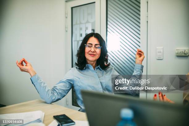 a group of businessmen meditate in the office. - man eyes closed stock pictures, royalty-free photos & images