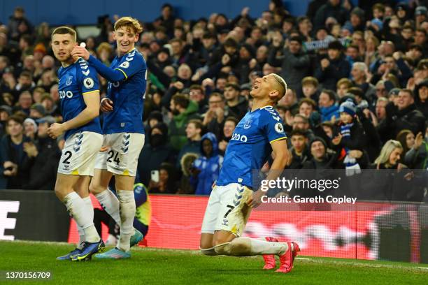 Richarlison of Everton celebrates with teammates Jonjoe Kenny and Anthony Gordon after scoring their team's third goal during the Premier League...