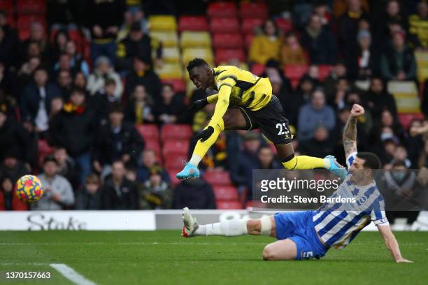 Ismaila Sarr of Watford FC shoots past Lewis Dunk of Brighton & Hove Albion during the Premier League match between Watford and Brighton & Hove...