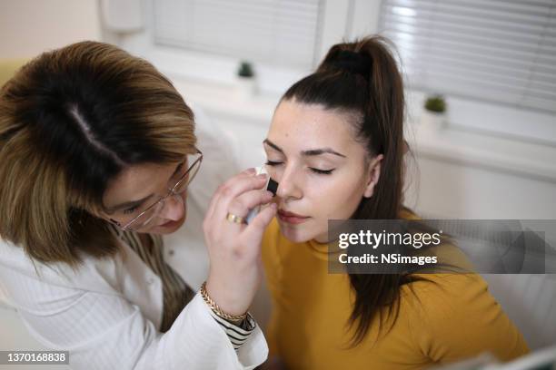dermatologist checking patient skin.stock photo - melanoma stock pictures, royalty-free photos & images