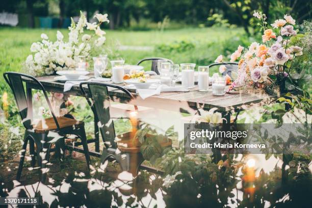 rustic wooden table with elegant festive setting decorated with fresh pastel aromatic flowers. - rustic elegance stock pictures, royalty-free photos & images