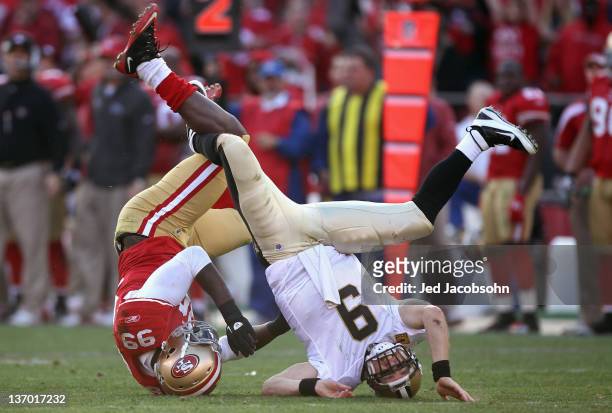 Drew Brees of the New Orleans Saints is sacked by Aldon Smith of the San Francisco 49ers in the third quarter of the NFC Divisional playoff game at...