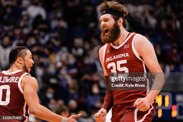 Tanner Groves of the Oklahoma Sooners celebrates hitting a 3 point shot against the Kansas Jayhawks during the first half at Allen Fieldhouse on...