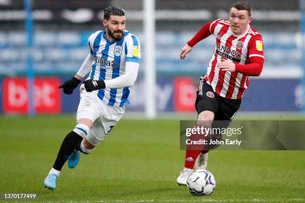 Gonzalo Avila 'Pipa' of Huddersfield Town runs away from John Fleck of Sheffield United during the Sky Bet Championship match between Huddersfield...