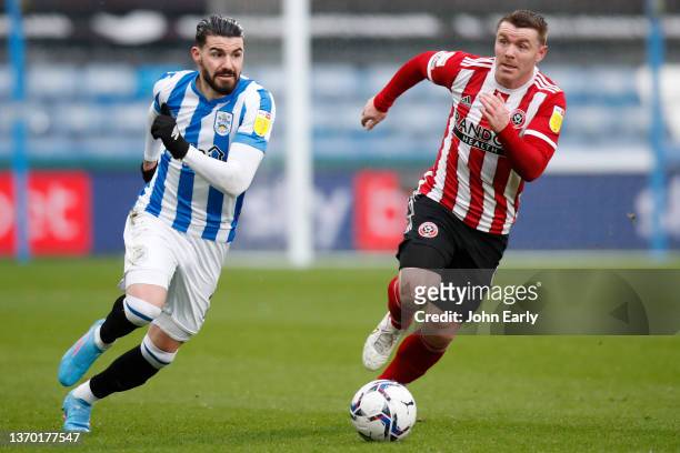 Gonzalo Avila 'Pipa' of Huddersfield Town runs away from John Fleck of Sheffield United during the Sky Bet Championship match between Huddersfield...