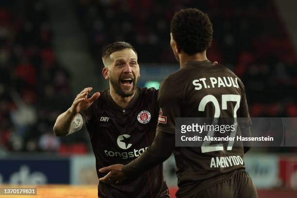 Etienne Amenyido of St. Pauli celebrates scoring the opening goal with his team mate Guido Burgstaller during the Second Bundesliga match between SSV...