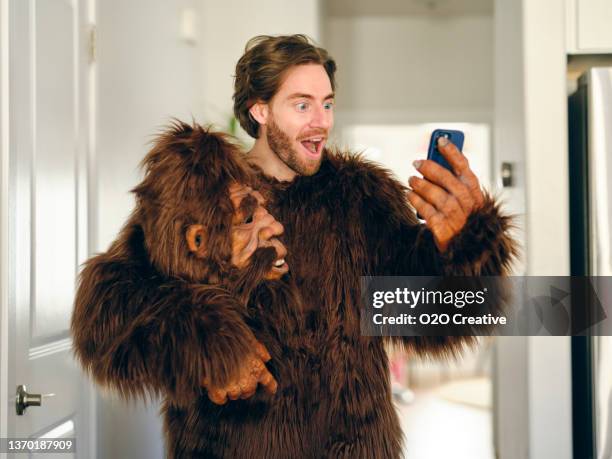 man playing online poker on a smartphone - monkey suit stock pictures, royalty-free photos & images