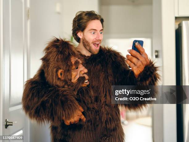 man playing online poker on a smartphone - man ape stock pictures, royalty-free photos & images