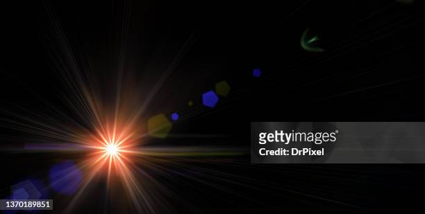 light with lens flare against black background - riflesso foto e immagini stock