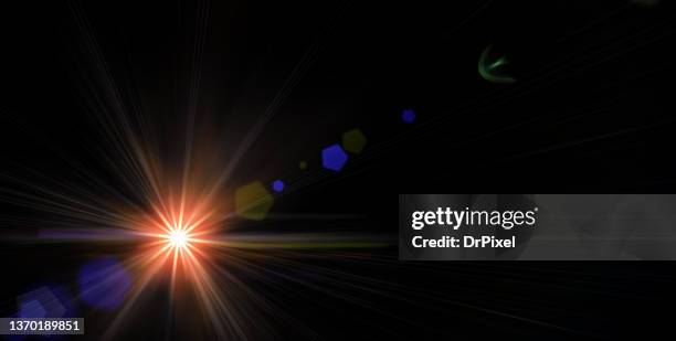 light with lens flare against black background - レンズフレア　黒バック ストックフォトと画像