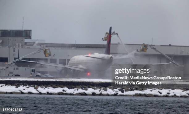February 4: Canceled flights, plane de-icing and runway clearing at Logan Int. Airport on February 4, 2022 in BOSTON, Massachusetts.
