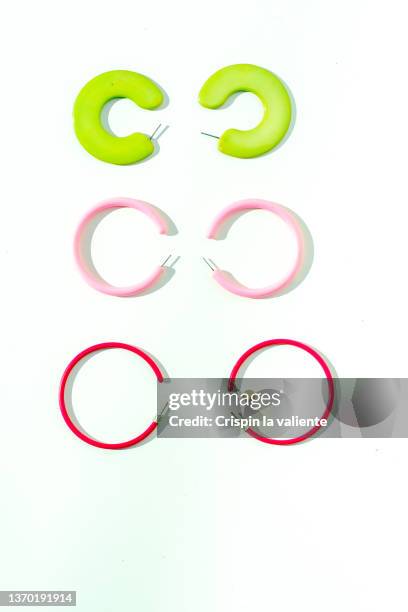 colored earrings, beads, on white background - orecchino ad anello foto e immagini stock