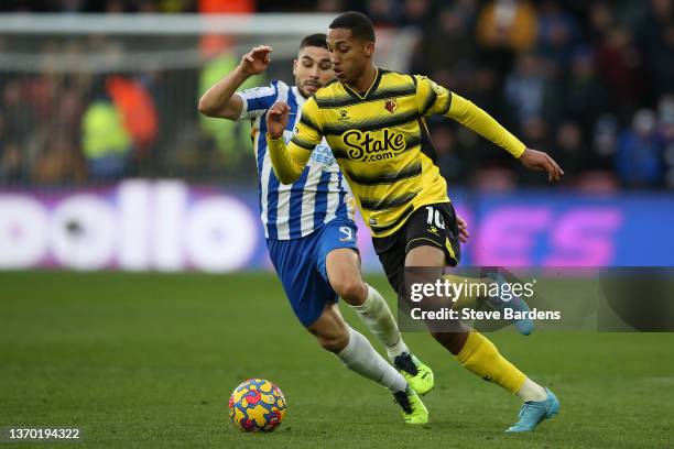 Joao Pedro of Watford FC breaks away fro Neal Maupay of Brighton & Hove Albion during the Premier League match between Watford and Brighton & Hove...