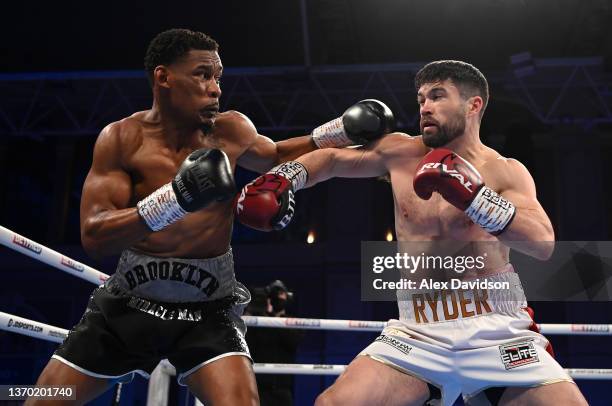 Daniel Jacobs and John Ryder exchange punches during the super-middleweight fight between Daniel Jacobs and John Ryder at Alexandra Palace on...