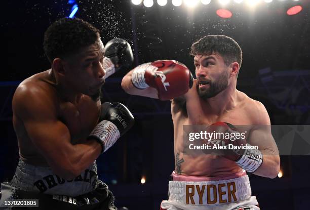 John Ryder punches Daniel Jacobs during the super-middleweight fight between Daniel Jacobs and John Ryder at Alexandra Palace on February 12, 2022 in...