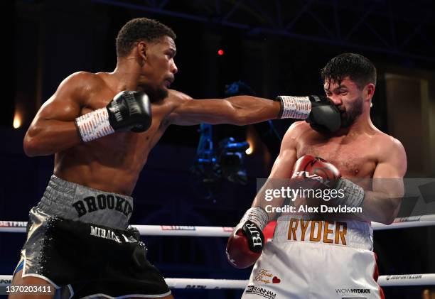 Daniel Jacobs punches John Ryder during the super-middleweight fight between Daniel Jacobs and John Ryder at Alexandra Palace on February 12, 2022 in...