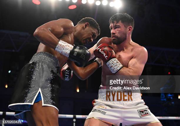 Daniel Jacobs and John Ryder exchange punches during the super-middleweight fight between Daniel Jacobs and John Ryder at Alexandra Palace on...