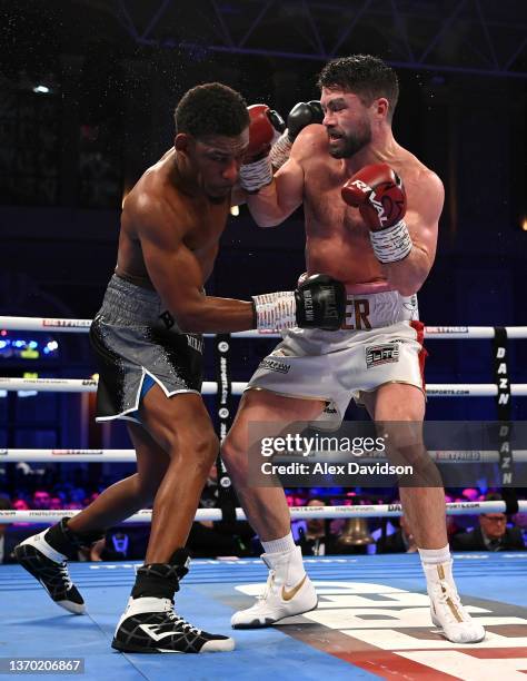 Daniel Jacobs and John Ryder exchange punches during the super-middleweight fight between Daniel Jacobs and John Ryder at Alexandra Palace on...