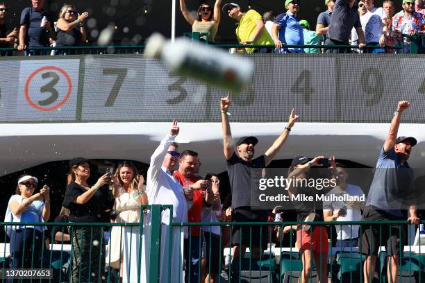 Fans cheer in the stands on the 16th hole after a hole-in-one by Sam Ryder of the United States during the third round of the WM Phoenix Open at TPC...