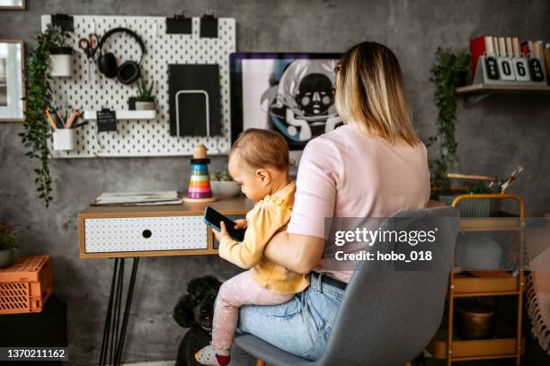 multitasking work and playing with daughter - innocence stock pictures, royalty-free photos & images