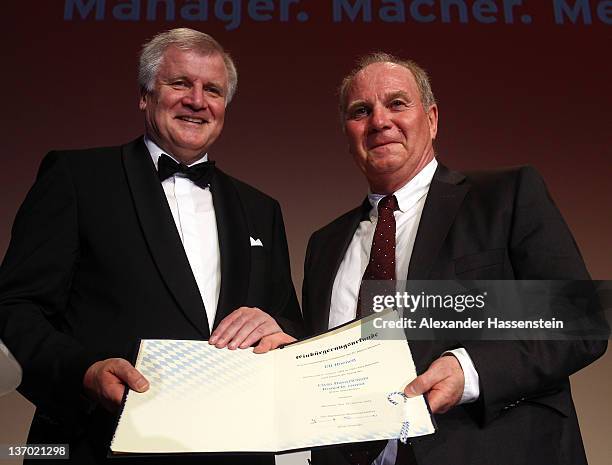 Horst Seehofer, Chairman of the Christian Social Union , hands over a Bavarian certificate of naturalization to Uli Hoeness at Uli Hoeness' 60th...