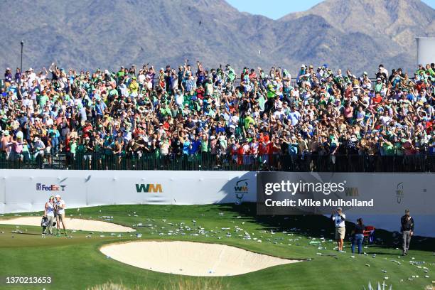 Bottles litter the 16th hole after a hole-in-one by Sam Ryder of the United States during the third round of the WM Phoenix Open at TPC Scottsdale on...