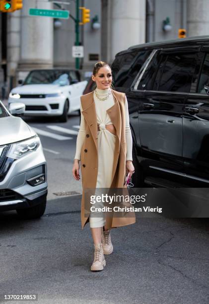 Olivia Palermo seen wearing sleeveless beige coat, dress outside PatBo during New York Fashion Week on February 12, 2022 in New York City.