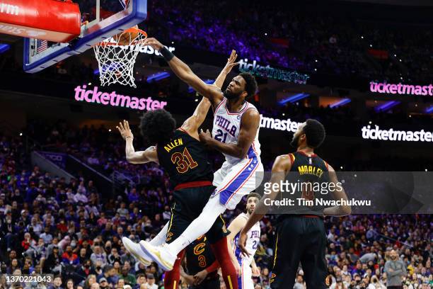 Joel Embiid of the Philadelphia 76ers dunks over Jarrett Allen of the Cleveland Cavaliers during the second quarter at Wells Fargo Center on February...