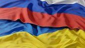 Waving colorful flag of russia and national flag of ukraine