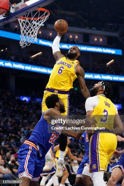 LeBron James of the Los Angeles Lakers dunks the ball in the first half against the Golden State Warriors at Chase Center on February 12, 2022 in San...