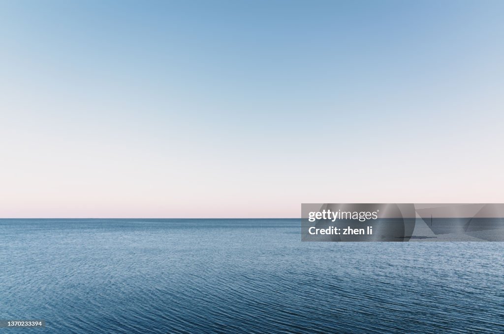 Calm sea fading into the sky at dusk