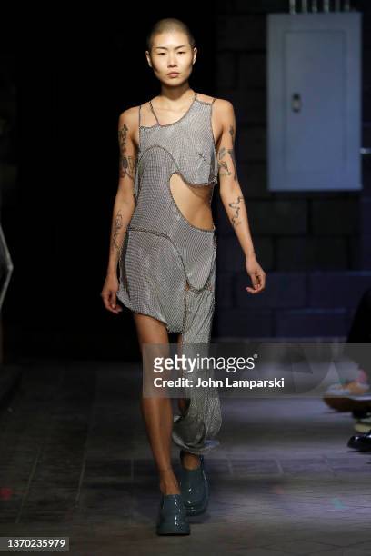 Model walks the runway wearing Eckhaus Latta fall fashions during New York Fashion Week at Old Essex Street Market on February 12, 2022 in New York...