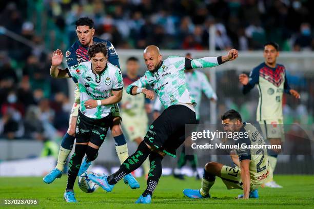 Matheus Doria and Alan Cervantes of Santos struggles for the ball with Diego Valdes and Henry Martin of America during the 5th round match between...