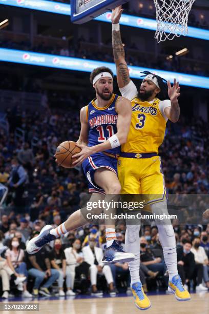 Klay Thompson of the Golden State Warriors goes to the basket against Anthony Davis of the Los Angeles Lakers in the second half at Chase Center on...