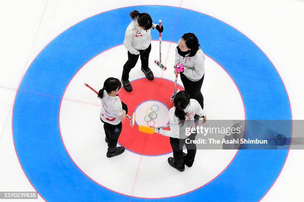 Members of Team Japan huddle after the 2nd end during the Curling Women's Round Robin game against Team ROC on Day Eight of the Beijing 2022 Winter...