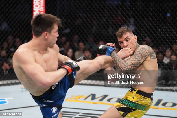 Alexander Hernandez kicks Renato Moicano of Brazil in their lightweight fight during the UFC 271 event at Toyota Center on February 12, 2022 in...