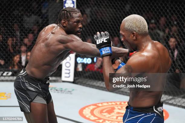 Jared Cannonier punches Derek Brunson in their middleweight fight during the UFC 271 event at Toyota Center on February 12, 2022 in Houston, Texas.