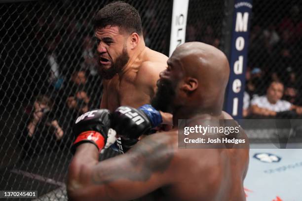 Tai Tuivasa of Australia punches Derrick Lewis in their heavyweight fight during the UFC 271 event at Toyota Center on February 12, 2022 in Houston,...