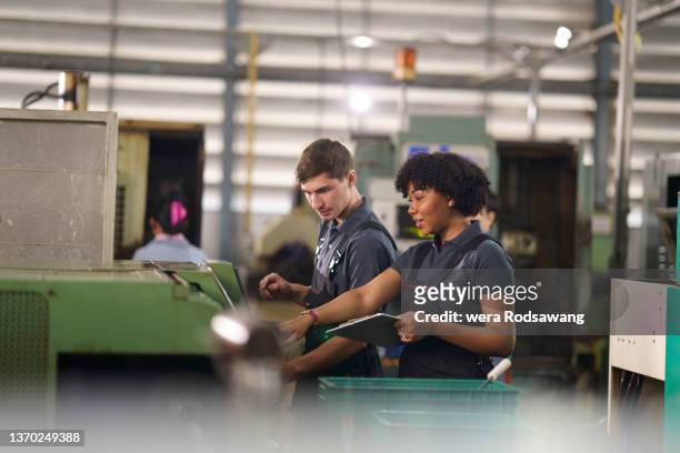 industrial technicians inspecting manufacturing control system - production line worker stock pictures, royalty-free photos & images