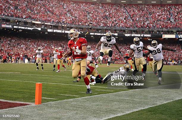 Alex Smith of the San Francisco 49ers runs in for a touchdown against the New Orleans Saints during the fourth quarter of their NFC Divisional...