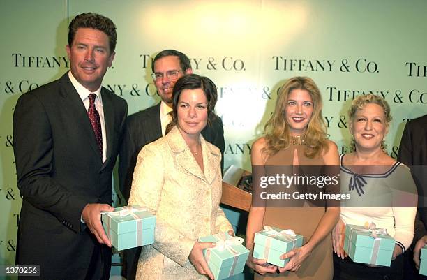 Retired quarterback Dan Marino , actress Marcia Gay Harden, author Candace Bushnell, and actress Bette Midler hold gift boxes containing Tiffany Mark...