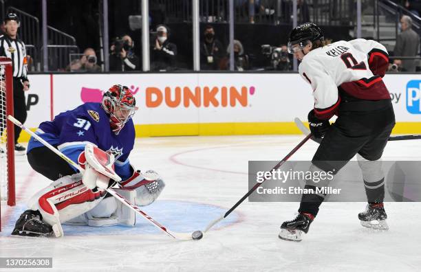 Frederik Andersen of the Carolina Hurricanes blocks a shot by Clayton Keller of the Arizona Coyotes during the game between the Metropolitan Division...