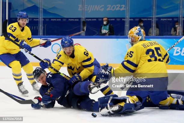 Leo Komarov of Team Finland challenges Jonathan Pudas of Team Sweden in the first period during the Men's Ice Hockey Preliminary Round Group C match...