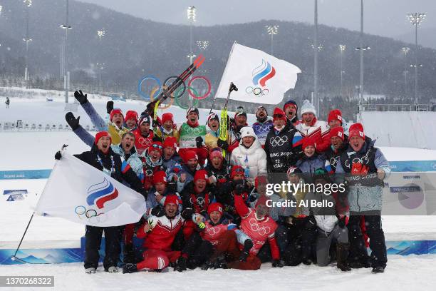Gold medallists Alexey Chervotkin, Alexander Bolshunov, Denis Spitsov and Sergey Ustiugov of Team ROC celebrate with their team and staff during the...