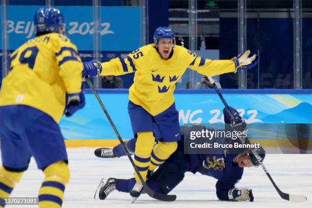 Forward Jacob de la Rose of Team Sweden challenged by forward Hannes Bjorninen of Team Finland during the Men's Ice Hockey Preliminary Round Group C...