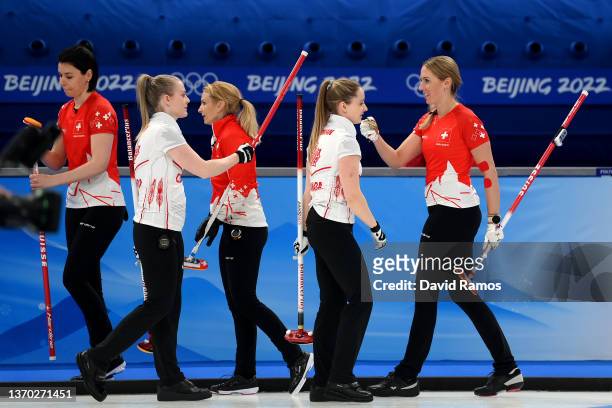 Melanie Barbezat, Silvana Tirinzoni and Esther Neuenschwander of Team Switzerland celebrate their victory against Team Canada during the Women's...