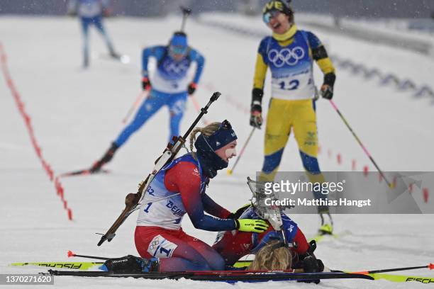Gold medallist Marte Olsbu Roeiseland of Team Norway and Bronze medallist Tiril Eckhoff of Team Norway interact after the Biathlon Women's 10km...