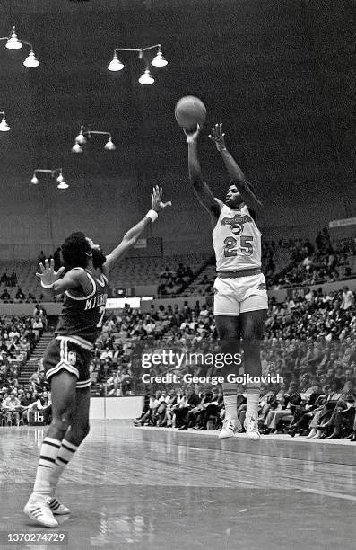 Guard George Thompson of the Pittsburgh Condors of the American Basketball Association shoots the ball as guard Lucius Allen of the Milwaukee Bucks...