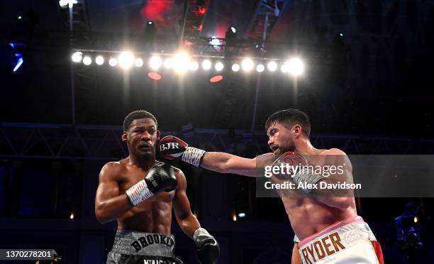 John Ryder punches Daniel Jacobs during the super-middleweight fight between Daniel Jacobs and John Ryder at Alexandra Palace on February 12, 2022 in...